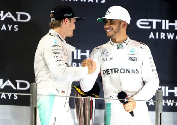 Lewis Hamilton congratulates Nico Rosberg on the podium after the Abu Dhabi Grand Prix at the Yas Marina Circuit