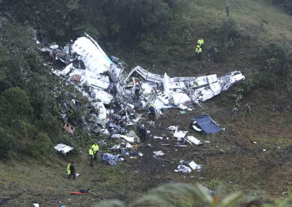 Police officers and rescue workers search for survivors around the wreckage of a chartered airplane that crashed in La Union, a mountainous area outside Medellin, Colombia, Tuesday, Nov. 29, 2016. The plane was carrying the Brazilian first division soccer club Chapecoense team that was on it's way for a Copa Sudamericana final match against Colombia's Atletico Nacional. (AP Photo/Luis Benavides)