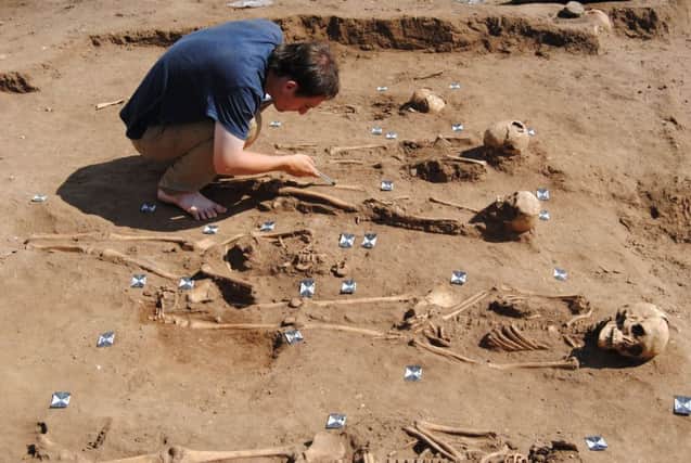 More than half of 48 skeletons found in an "extremely rare" 14th-century Black Death burial pit were those of children, archaeologists said.