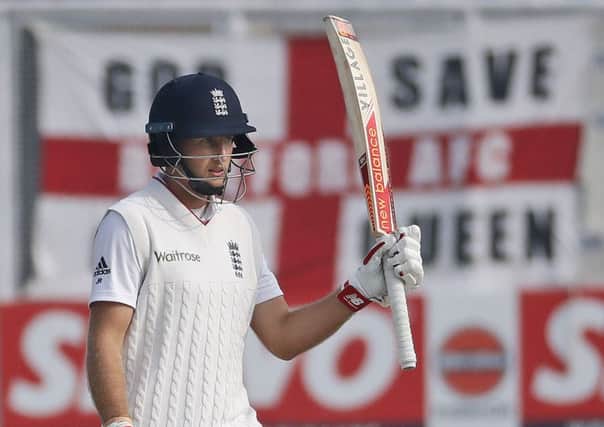 England's Joe Root raises his bat after scoring a half-century on the fourth day of the third Test against India in Mohali (Picture: Altaf Qadri/AP).