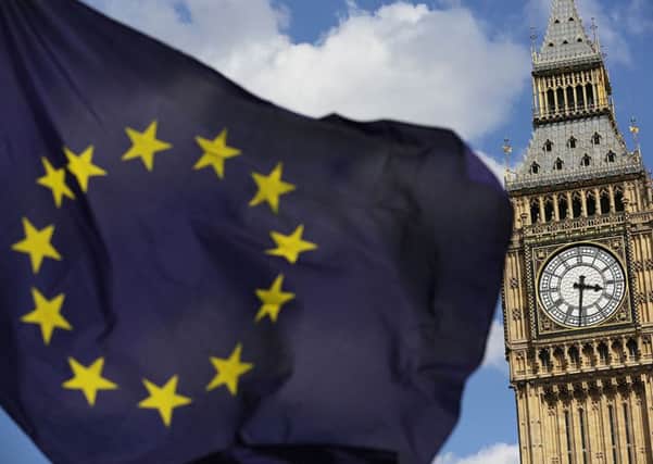 File photo dated 02/07/16 of a European Union flag in front of Big Ben, as Britain faces paying into the European Union (EU) for more than a decade after it quits the bloc, Germany's finance minister has said. PRESS ASSOCIATION Photo. Issue date: Friday November 18, 2016. The UK will still be bound by tax rules that stop it from incentivising investors to stay in the country and its commitments to Brussels will "last beyond exit", Wolfgang Schauble warned. See PA story POLITICS Brexit. Photo credit should read: Daniel Leal-Olivas/PA Wire