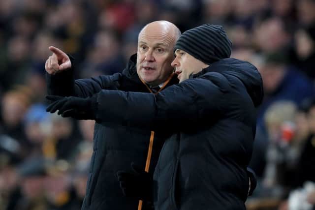 Hull City manager Mike Phelan (left) speaks with fourth official Stuart Attwell at the KCOM Stadium on Tuesday night. Picture: Mike Egerton/PA.