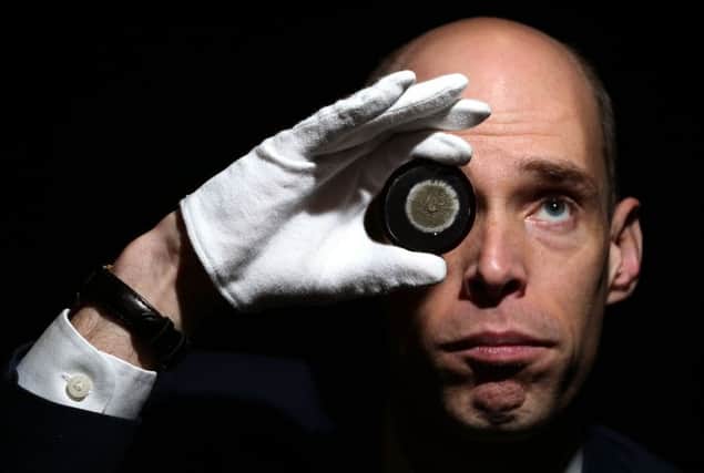 Joseph Marshall, Head of Special Collections at the University of Edinburgh, takes a closer look at a petri dish that holds a sample of mould that enabled Alexander Fleming to discover the antibiotic power of penicillin