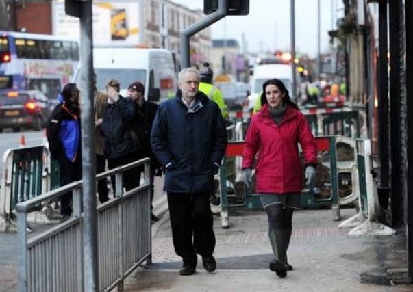 jeremy Corbyn inspects the flooding damage on Kirkstall Road, Leeds, with local MP Rachel Reeves on New Year's Eve last year.