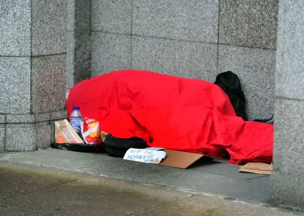 TRYING TO KEEP WARM: A rough sleeper in Leeds.