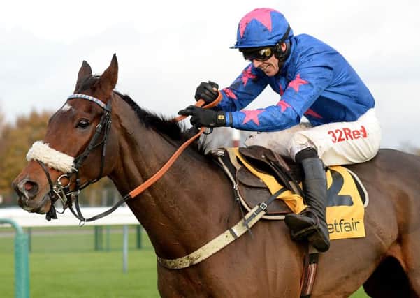 Cue Card ridden by Paddy Brennan after clearing the final fence to win the Betfair Steeple Chase during Betfair Chase day at Haydock Racecourse. (Picture: Anna Gowthorpe/PA Wire)