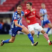 Battling for the cause: Barnsleys Josh Scowen, blocked by Wigans Shaun MacDonald, remains confident.