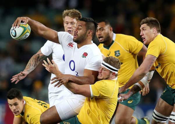 England's Billy Vunipola attempts to offload while being tackled by Australia's James Slipper during their rugby union test match in Sydney, Saturday, June 25, 2016.