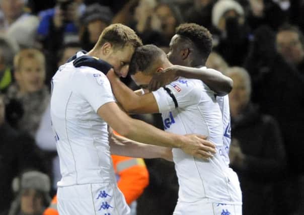 Kemar Roofe is congratulated after heading home his first goal for Leeds United, against Aston Villa (Picture: Simon Hulme).