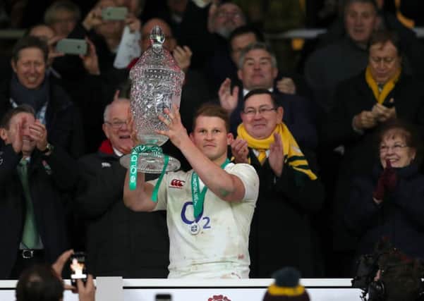 England's Dylan Hartley celebrates with the Autumn International trophy after beating Australia. Picture: David Davies/PA.