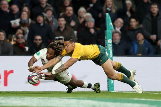 England's Marland Yarde scores a try past Australia's Israel Folau. Picture: David Davies/PA