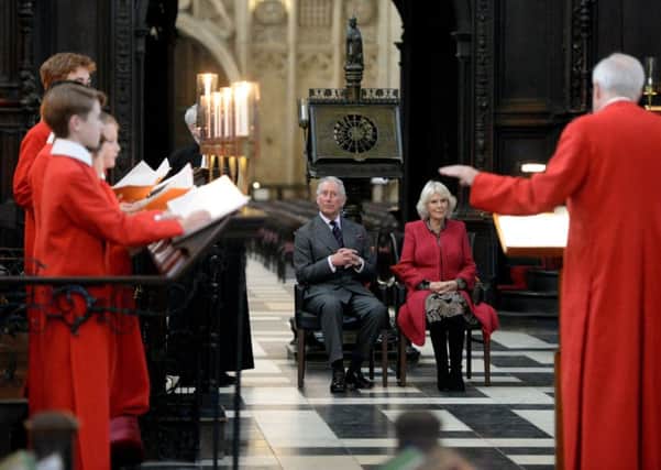 The Prince of Wales and the Duchess of Cornwall listen to a rehearsal by King's College Choir during a visit to the college chapel at King's College Cambridge.