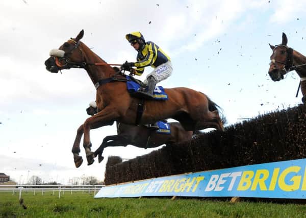 The Last Samuri, ridden by David Bass, clears a fence on its way to winning the BetBright Grimthorpe Chase at Doncaster in March (Picture: Anna Gowthorpe/PA Wire).