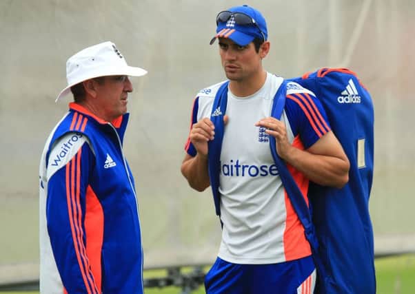 England captain Alastair Cook chats with coach Trevor Bayliss.