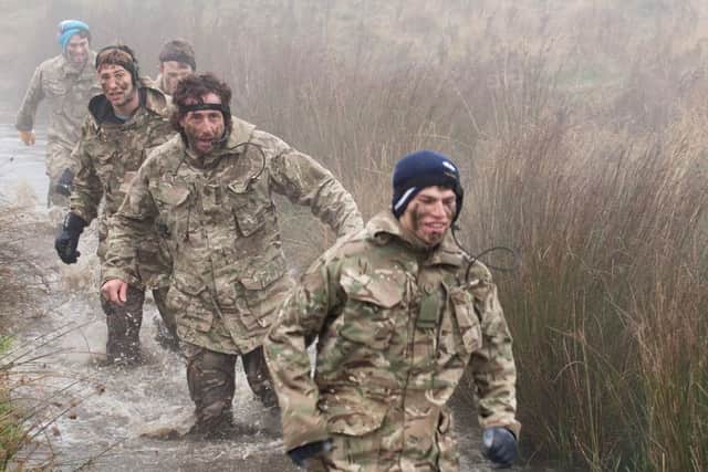 Members of the Yorkshire Cricket team wade through cold water during vehicle recover exercise on Catterick Training area. On their way to collect rowing equipment. 

Soldiers from the Yorkshire Regiment put their cricketing heroes through agony and ecstasy on the ranges at Catterick Garrison, North Yorkshire, on the 6th December 2016.
On a frosty and foggy day the troops from 2nd Battalion The Yorkshire Regiment ran the Yorkshire County Cricket Club first team squad, including Yorkshire and England stars Ryan Sidebottom, Liam Plunkett and Tim Bresnan, ragged with a variety of challengers.
One of the most difficult was having to winch a bogged down Land Rover out of a four foot trench full of water, before that collecting equipment from the top of a hill.