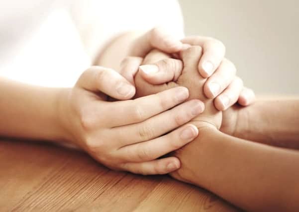 The hand of friendship - nine million people suffer from loneliness according to new research.