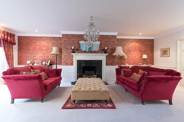 The sitting room with Zoffany wallpaper and an original Georgian fireplace