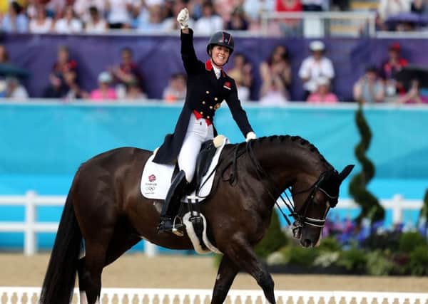 Take a bow: Charlotte Dujardin celebrates winning gold at the London 2012 Olympics on board Valegro. (Picture: Steve Parsons/PA)
