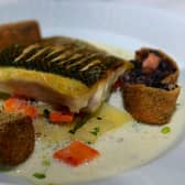Sea bass, paysanne vegetables, smoked salmon quince and a black pudding croquet.
