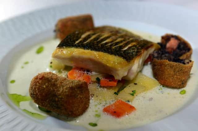 Sea bass, paysanne vegetables, smoked salmon quince and a black pudding croquet.