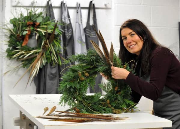 Lucy MacNicoll working on one of her Christmas wreaths at her workshop in Harrogate.