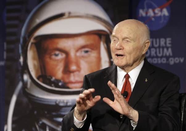 FILE - In this Feb. 20, 2012, file photo, U.S. Sen. John Glenn talks with astronauts on the International Space Station via satellite before a discussion titled "Learning from the Past to Innovate for the Future" in Columbus, Ohio. Glenn, who was the first U.S. astronaut to orbit Earth and later spent 24 years representing Ohio in the Senate, has died at 95. (AP Photo/Jay LaPrete, File)
