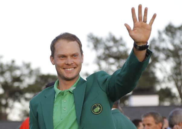 Perfect fit: Masters champion and Rotherham Golf Club member Danny Willett wears the green jacket as he waves to supporters after his victory by three shots over American Jordan Spieth in April in Augusta, Georgia. (Picture: AP Photo/Jae C. Hong)
