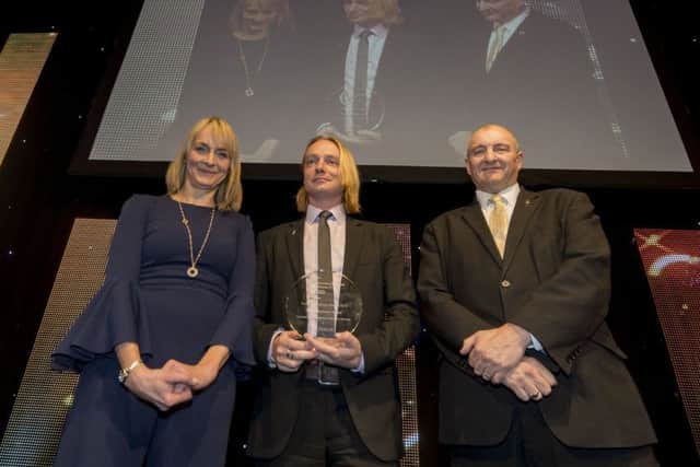 Date:9th December 2016. Picture James Hardisty. 30th Anniversary Yorkshire Business Awards 2016, held at The Queen's Hotel, Leeds. Pictured Host, Louise Minchin, and (right) Simon Baldwin, Head of Enterprise Services at Leeds Beckett University, presenting the winner of the Yorkshire Young Business of the Year Award to (centre) Sam Chapman, Director Co-Founder and Chief Innovation Officer of the Floow Limited.
