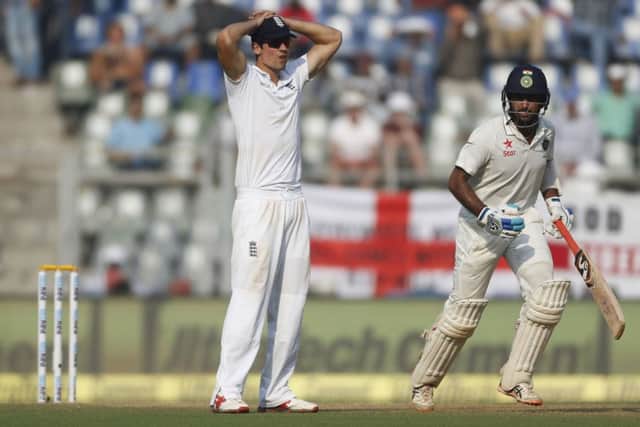 Indian batsman Cheteshwar Pujara, right, runs between the wicket as England's captain Alastair Cook reacts. (AP Photo/Rafiq Maqbool)