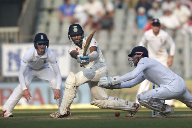 Indian batsman Cheteshwar Pujara, second from leftsweeps past Jonny Bairstow. (AP Photo/Rafiq Maqbool)