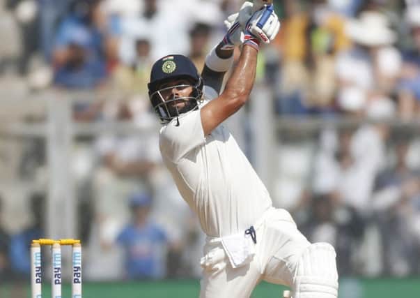 Indian cricket captain Virat Kohli bats on the fourth day of the fourth cricket test match between India and England in Mumbai. (AP Photo/Rafiq Maqbool)