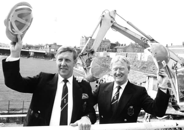 It was helmets off for Bradford City chairman Stafford Heginbotham (left) and his vice-chairman and project director Jack Tordoff as work started on the Â£2.3m. contract to rebuild the fire ravaged Valley Parade Ground.