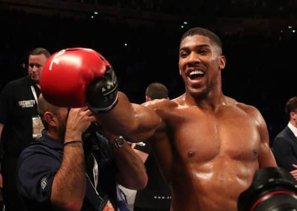 Anthony Joshua celebrates after beating Eric Molina (Picture: Peter Byrne/PA Wire).