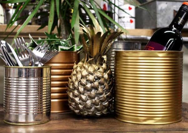 Upcycle tin cans by spraying them in silver, gold and brass