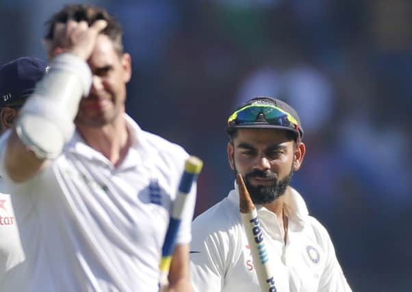 England's batsman James Anderson, left, reacts as Indian captain Virat Kohli, right, looks at stump after their win over England on the fifth day of the fourth cricket test match between India and England in Mumbai. (AP Photo/Rafiq Maqbool)