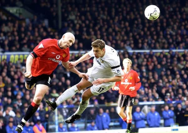 Jaap Stam, seen playing for Manchester United and getting the better of Leeds Uniteds Alan Smith at a hostile Elland Road in 2001, returns tonight as Readings manager (Picture: John Giles/PA Wire).