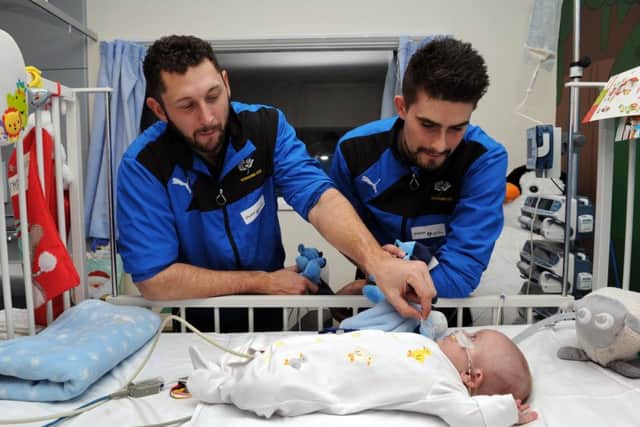 Yorkshire players Tim Bresnan and Will Rhodes meet Kobi Besley at Leeds General Infirmary, as part of new charity partnership with the children's heart surgery fund.
 Picture: Jonathan Gawthorpe.