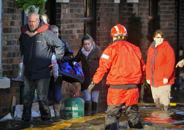 Families being rescued from floods last winter.