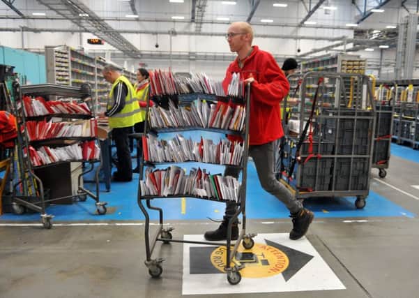 14 December 2016 .......       Rob Galloway busy sorting Christmas post in the Royal Mail Sorting Office at Stourton, Leeds.
 Royal Mail expects to handle millions of items of Christmas mail in Leeds Mail Centre on its busiest day - December 14 2016.  Picture Tony Johnson