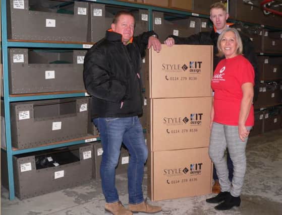 L-R Damian Dougdale, Julie Roberts and Style Uniform's newly appointed Marketing Manager, Peter Morris with a few of the boxes containing the jackets destined for HARC this Christmas. Damian and Peter and are wearing the jackets being donated.