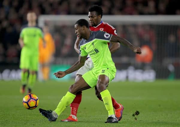 Middlesbrough's Adama Traore (back) and Liverpool's Georginio Wijnaldum (front) battle for the ball during the Premier League match at the Riverside Stadium