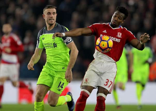 Liverpool's Jordan Henderson (left) and Middlesbrough's Adama Traore (right) battle for the ball during the Premier League match at the Riverside Stadium,