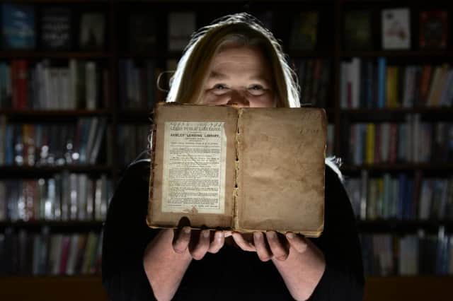 Librarian Hayley Goddard with the copy of 'The Siege of Troy' borrowed from Armley Library 110 years ago.  Picture: Bruce Rollinson