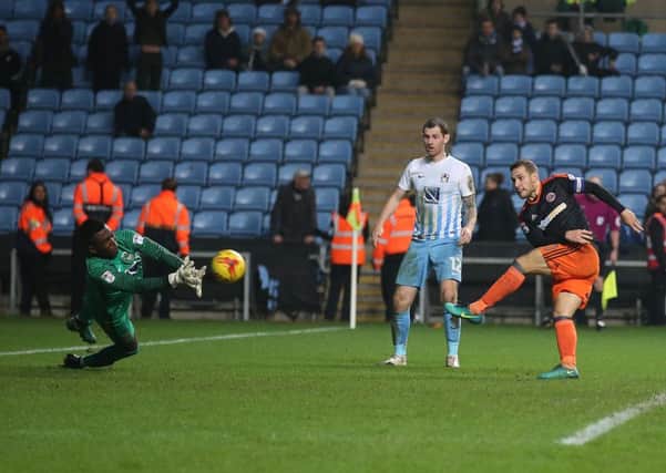 Billy Sharp cracks home his and Sheffield Uniteds second goal of the night to defeat Coventry City 2-1 in a match that was played against a backdrop of demonstrations against the Midlands clubs owners Sisu (Pictures: Simon Bellis/Sportimage).
