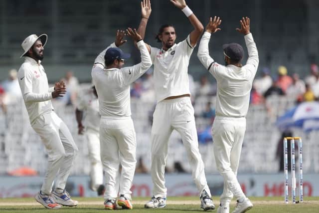 India's Ishant Sharma, second right, captain Virat Kohli, right, and team-mates celebrate the dismissal of Keaton Jennings