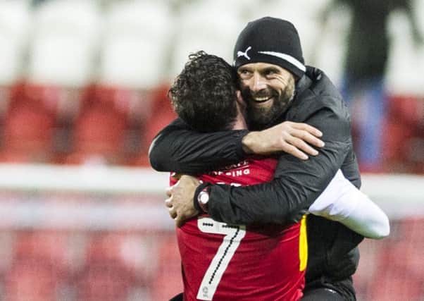Rotherham United's caretaker manager Paul Warne celebrates with Anthony Forde after the win over QPR.