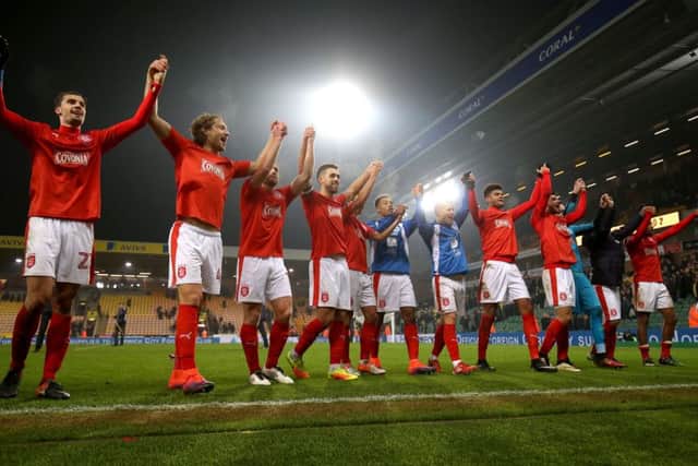 Huddersfield Town's players celebrate after the final whistle at Carrow Road. Picture: Chris Radburn/PA