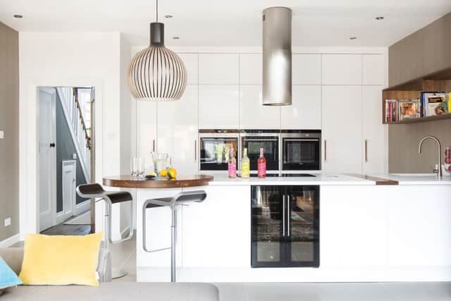 The kitchen units from T&S in Newton Aycliffe, are topped with two lengths of Silestone joined by a strip of walnut which ties in with the circular breakfast bar.
The bespoke bookshelves costÂ£800 and the kitchen stools Â£350 each from Forge Interiors