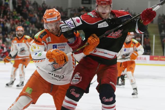 Zack Fitzgerald gets to grips with Cardiff Devils' player-coach, Andrew Lord, during Saturday's clash in South wales. Picture courtesy of Helen Brabon/EIHL.