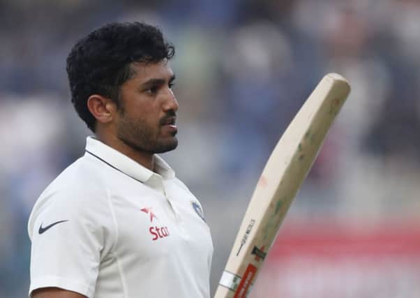 India's Karun Nair raises his bat after reaching 300 against England in Chenna (Picture: Tsering Topgyal/AP).